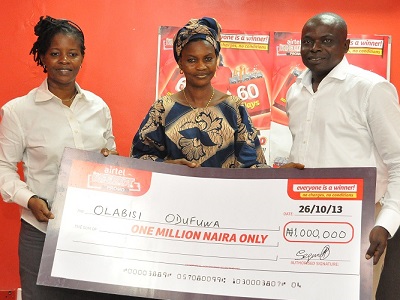 (L-r): Mrs Lynda Muibi, trade marketing mgr, Lagos North, Mrs Olabisi Odufuwa, winner of one millionaire in Airtel Red Hot Promo, with Mr Akinsola Omoniyi, Area Business Mgr, Airtel, Lagos North during the presentation of cheque to the first set of winner at Airtel Express Shop, Ogba, Lagos recently.